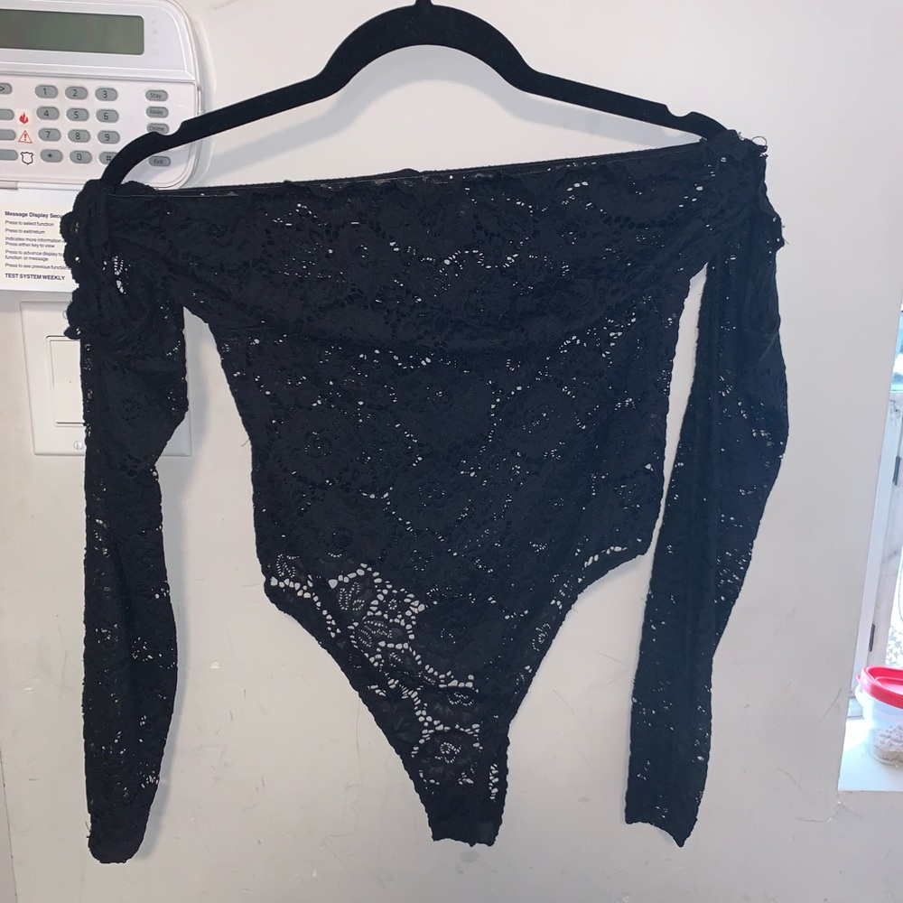 Black off the shoulder, long sleeves attached under. Thong bodysuit with snaps.